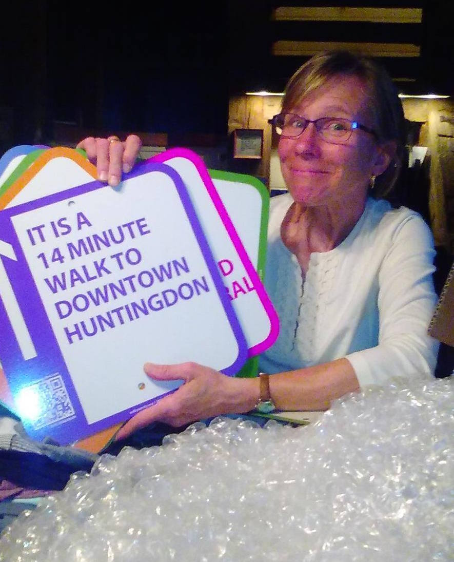 Pam Grugan with the first shipment of signage